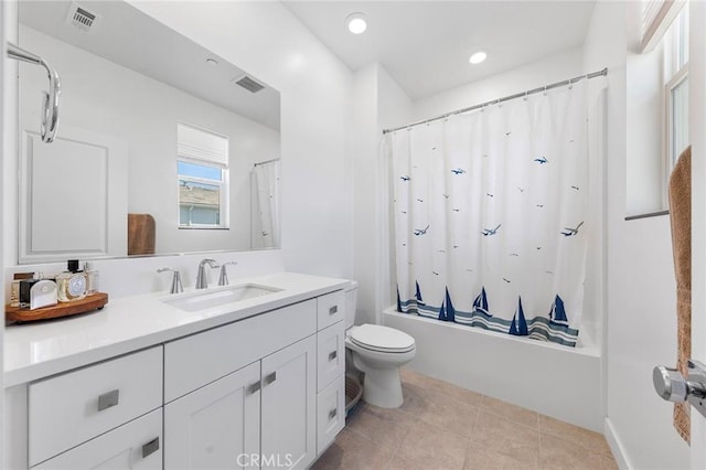 full bathroom with tile patterned flooring, shower / tub combo with curtain, vanity, and toilet