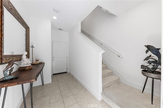 staircase featuring tile patterned flooring