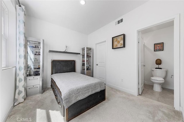 carpeted bedroom with ensuite bathroom