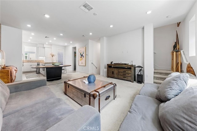 living room featuring light carpet