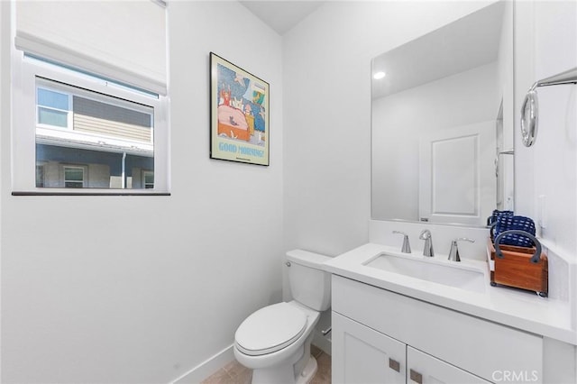 bathroom featuring tile patterned floors, vanity, and toilet