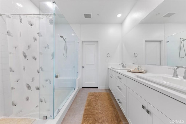 bathroom featuring a shower, vanity, and tile patterned floors