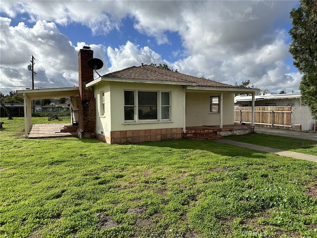 back of house with a lawn