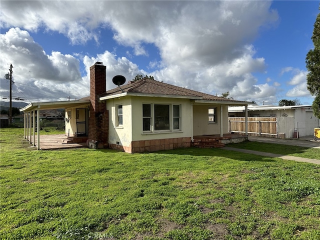 rear view of property with a lawn