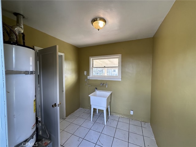 washroom with light tile patterned floors and water heater