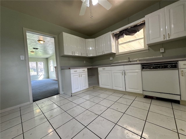 kitchen featuring dishwasher, light tile patterned floors, white cabinets, and sink