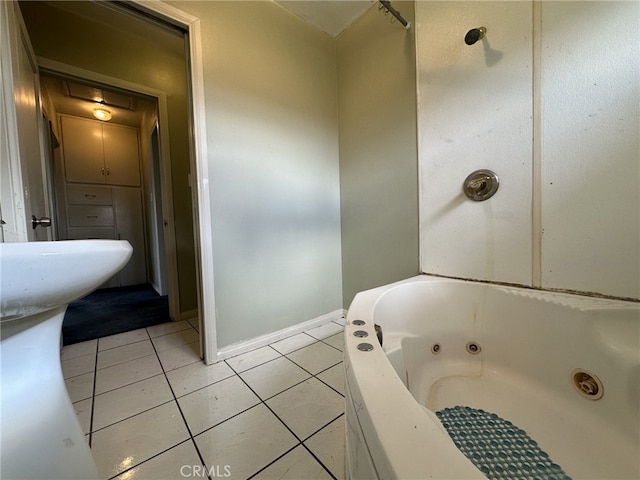 bathroom with tile patterned floors and a tub to relax in