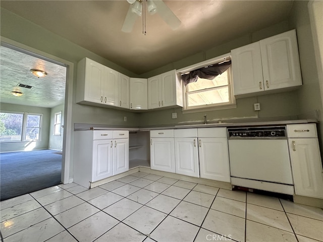 kitchen featuring white dishwasher, ceiling fan, white cabinets, and light tile patterned floors