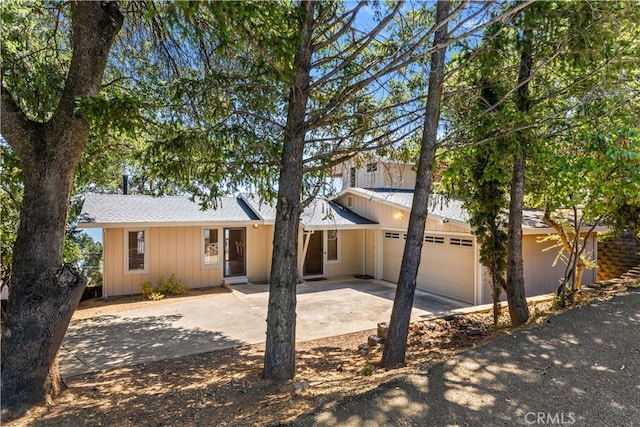 exterior space with a garage and concrete driveway