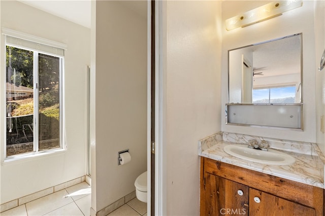 bathroom featuring tile patterned flooring, vanity, and toilet