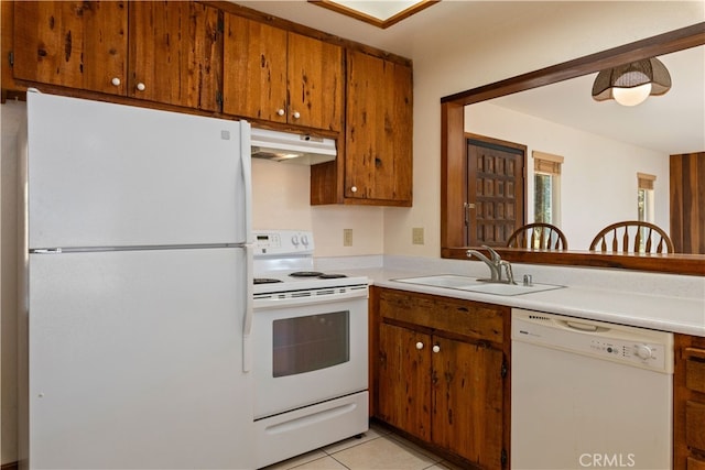 kitchen with white appliances, light tile patterned flooring, and sink