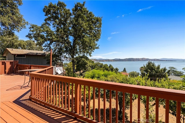 wooden deck featuring a water and mountain view