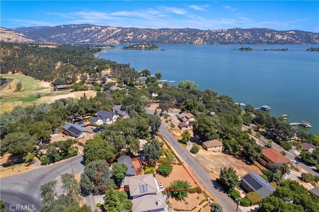 drone / aerial view with a water and mountain view