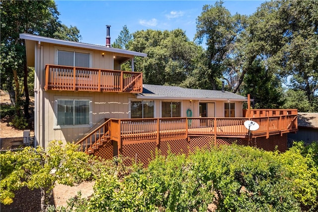 back of property with a wooden deck