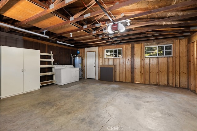 garage with water heater, separate washer and dryer, and a garage door opener