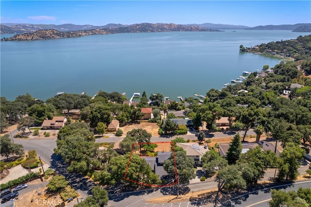 drone / aerial view with a water and mountain view