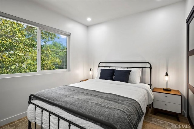 bedroom with dark wood-type flooring