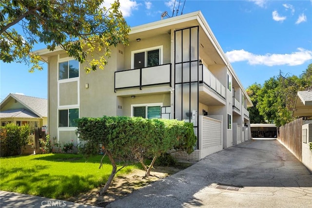 view of property exterior featuring a lawn and a balcony