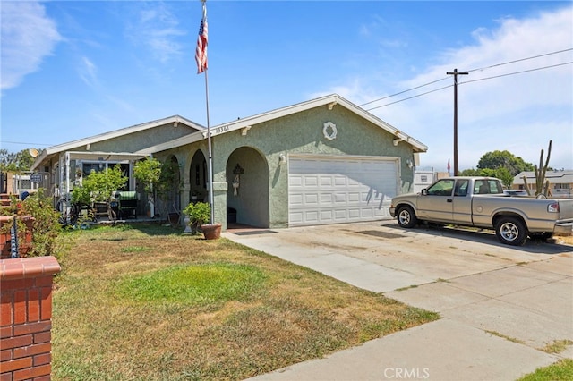 single story home with a garage and a front lawn