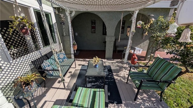 view of patio featuring a wooden deck and an outdoor living space