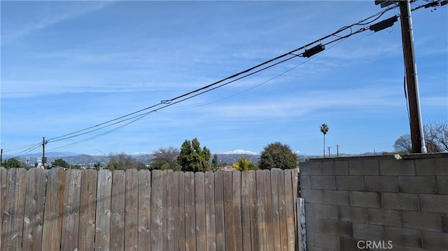 exterior space with fence and a mountain view