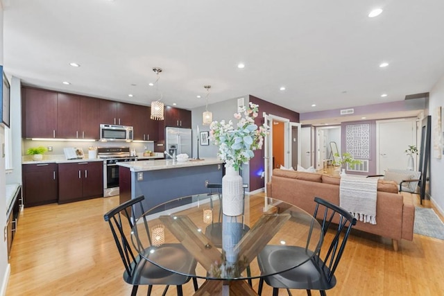 dining space featuring light wood-type flooring