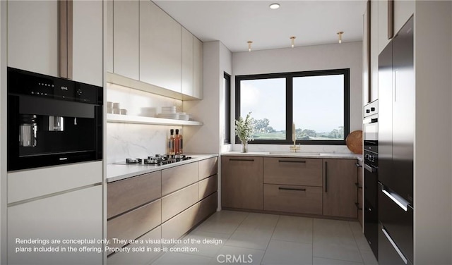 1 Gallery Pl, Newport Coast, CA 92657 - kitchen with stainless steel gas cooktop, light countertops, a sink, and black oven