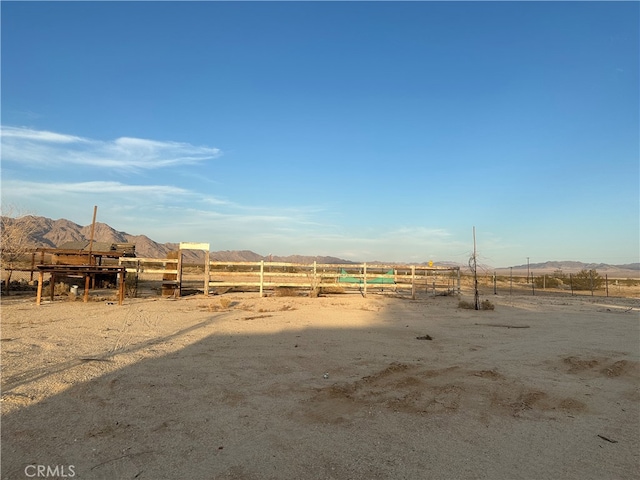 view of yard with a mountain view and a rural view