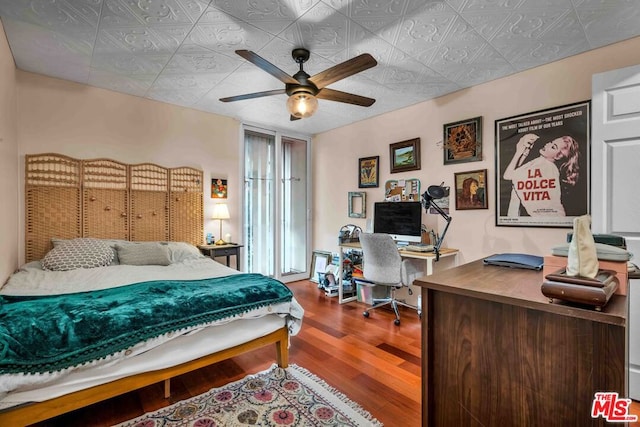 bedroom featuring wood-type flooring and ceiling fan