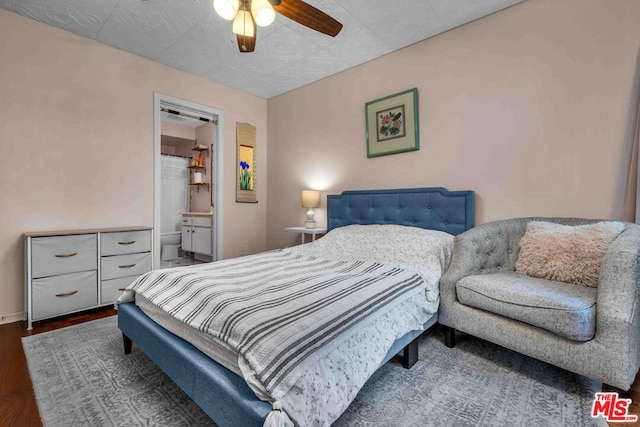 bedroom with connected bathroom, dark hardwood / wood-style flooring, and ceiling fan