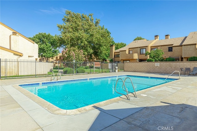 view of swimming pool with a patio