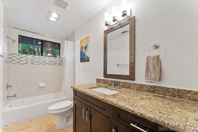 full bathroom with shower / bath combo with shower curtain, tile patterned floors, vanity, and toilet