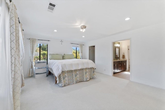 carpeted bedroom featuring ensuite bathroom