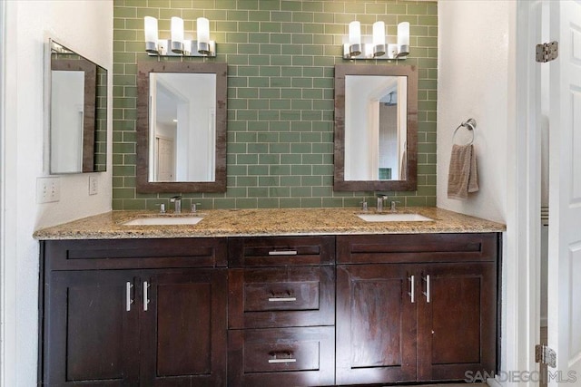 bathroom featuring vanity and backsplash