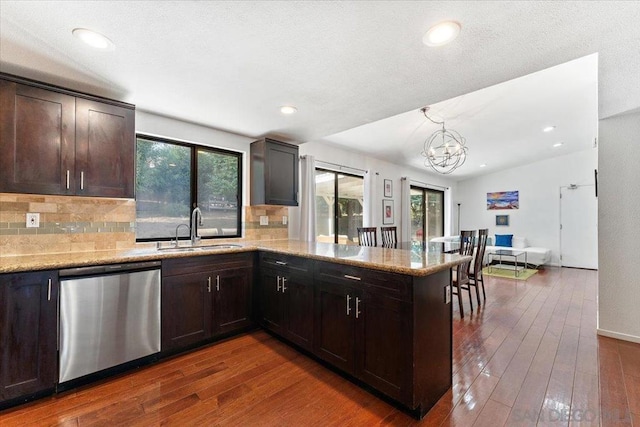 kitchen with kitchen peninsula, sink, a healthy amount of sunlight, and stainless steel dishwasher