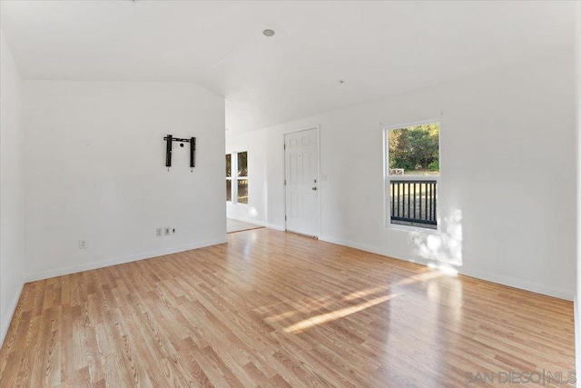 unfurnished living room with lofted ceiling and light hardwood / wood-style flooring