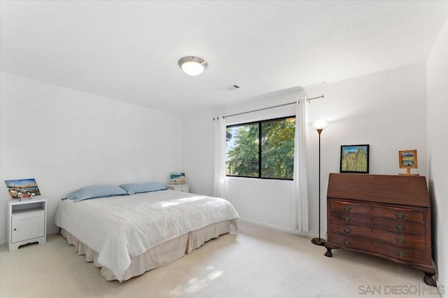 bedroom featuring light carpet