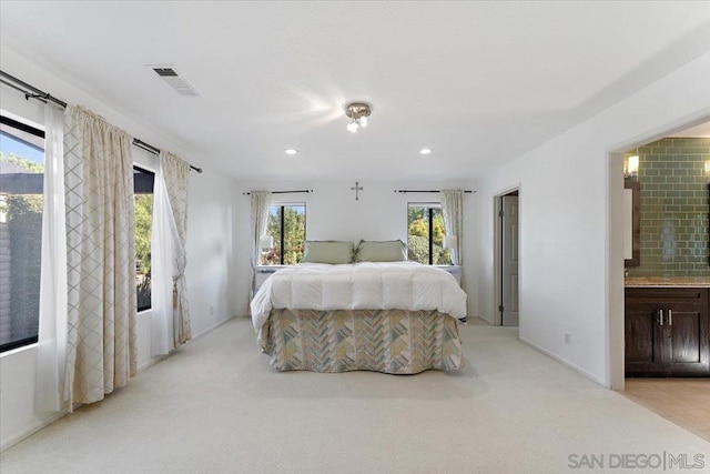 carpeted bedroom featuring connected bathroom