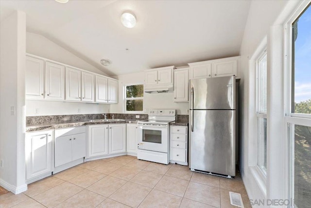 kitchen featuring white cabinetry, stainless steel refrigerator, light tile patterned floors, white electric stove, and lofted ceiling