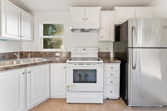 kitchen with sink, white cabinets, stainless steel refrigerator, light tile patterned floors, and white range with electric stovetop