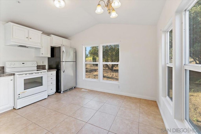 kitchen with white cabinets, light tile patterned flooring, lofted ceiling, stainless steel fridge, and electric range