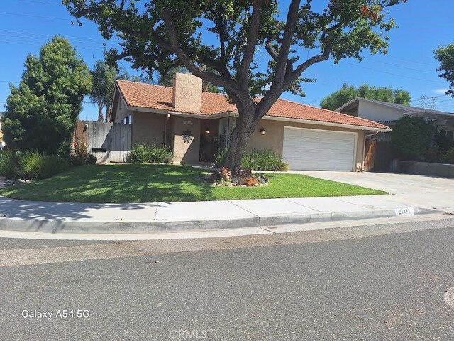 view of front of home with a garage and a front yard