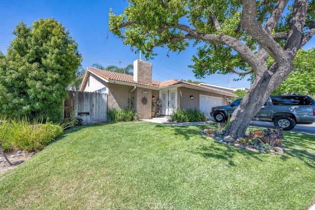 ranch-style house with a garage and a front yard