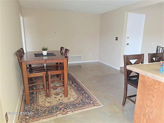 dining room featuring concrete flooring