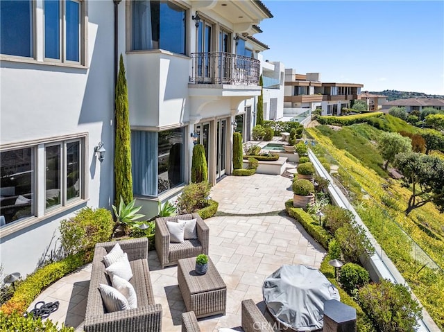 view of patio / terrace featuring a grill and a balcony