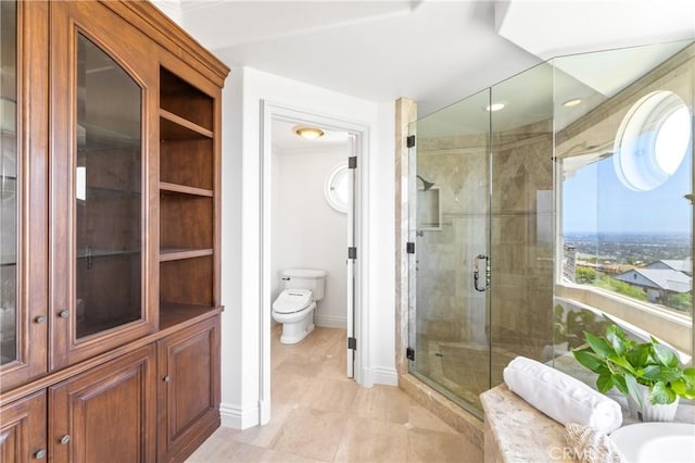 bathroom with tile patterned flooring, toilet, and walk in shower