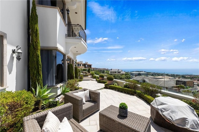 view of patio featuring a grill, a balcony, and an outdoor hangout area