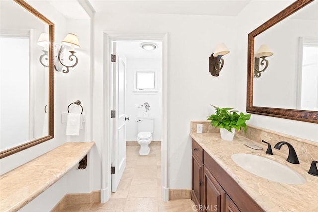 bathroom featuring tile patterned flooring, vanity, and toilet