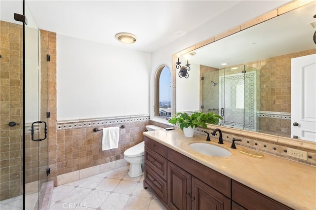 bathroom featuring walk in shower, tile patterned floors, toilet, vanity, and tile walls