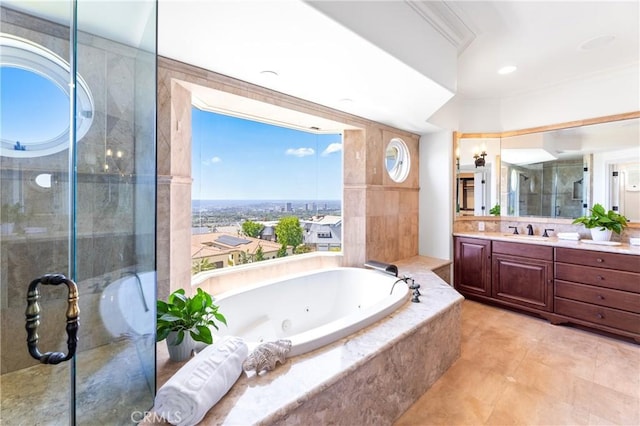 bathroom with tile patterned floors, vanity, separate shower and tub, and a wealth of natural light